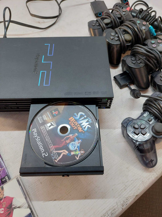 Sony Playstation 2 with 7 games, 6 controllers, 2 singstar microphones,cables