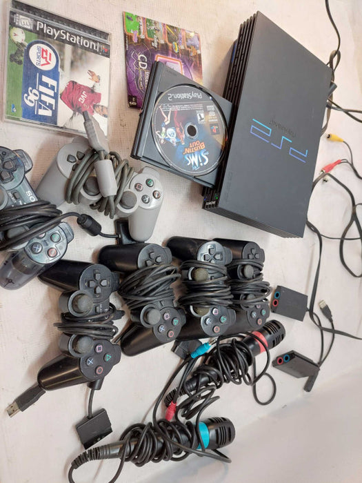 Sony Playstation 2 with 7 games, 6 controllers, 2 singstar microphones,cables