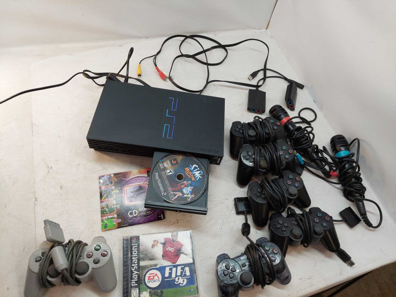 Sony Playstation 2 with 7 games, 6 controllers, 2 singstar microphones,cables