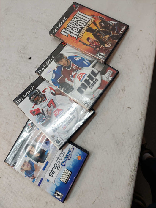 Sony Playstation 2 with 7 games, 6 controllers, 2 singstar microphones,cables