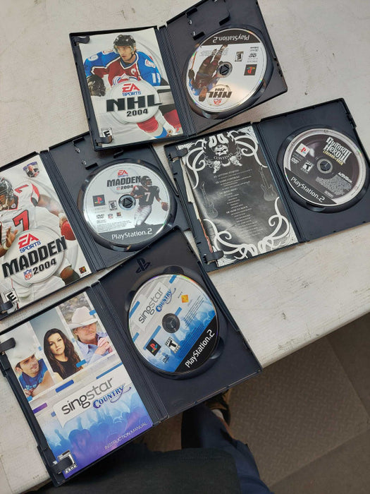 Sony Playstation 2 with 7 games, 6 controllers, 2 singstar microphones,cables